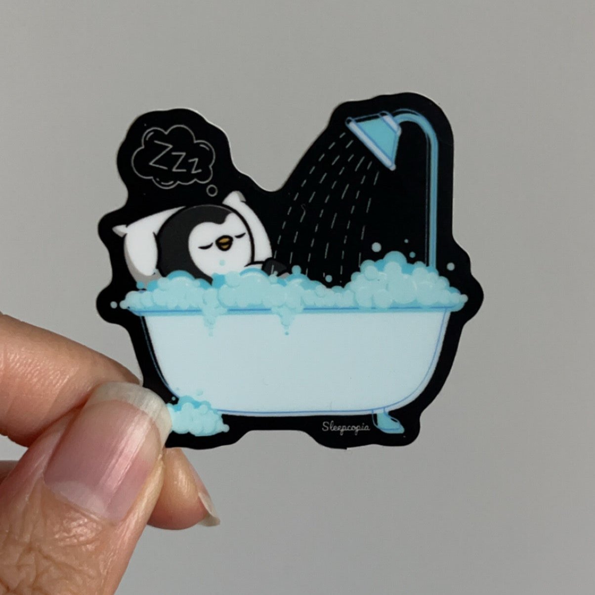Sleepy Penguin in Bathtub