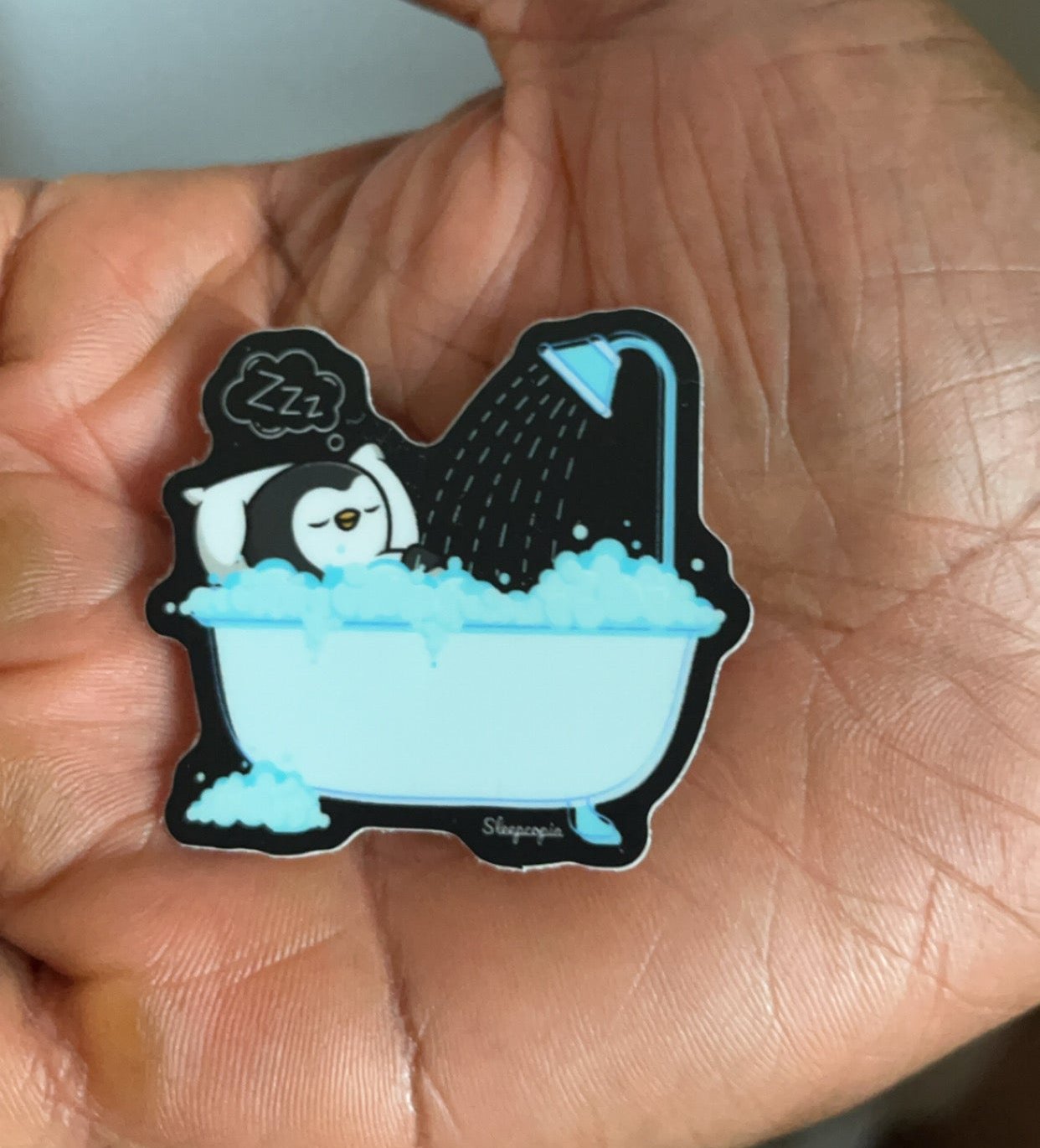 Sleepy Penguin in Bathtub